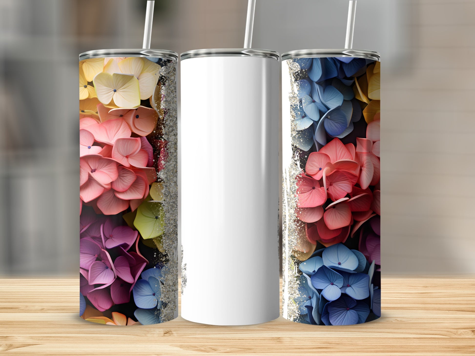 Three tumblers with floral designs and glitter accents.