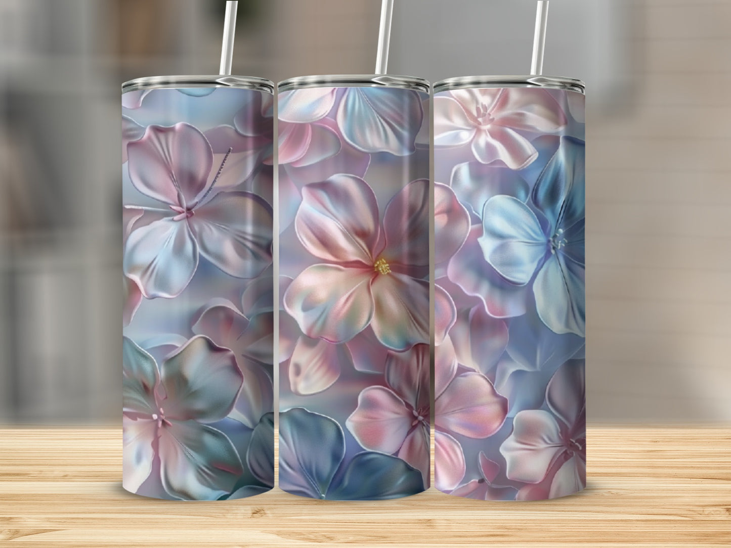 Three floral patterned tumblers with pastel pink and blue flowers.