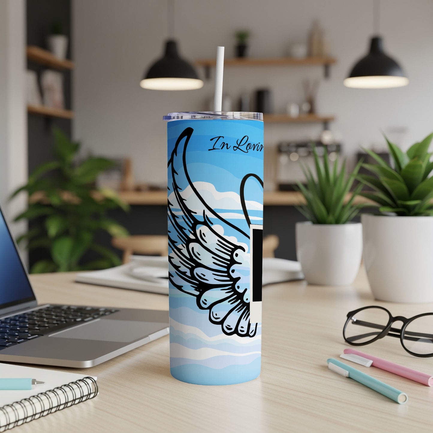 Blue tumbler with angel wing design and "In Loving Memory" text.