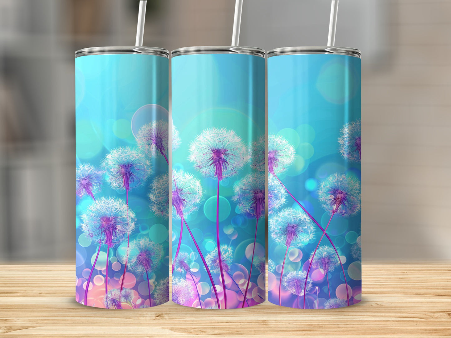 Three tumblers with dandelion and bokeh effect design on a wooden surface.
