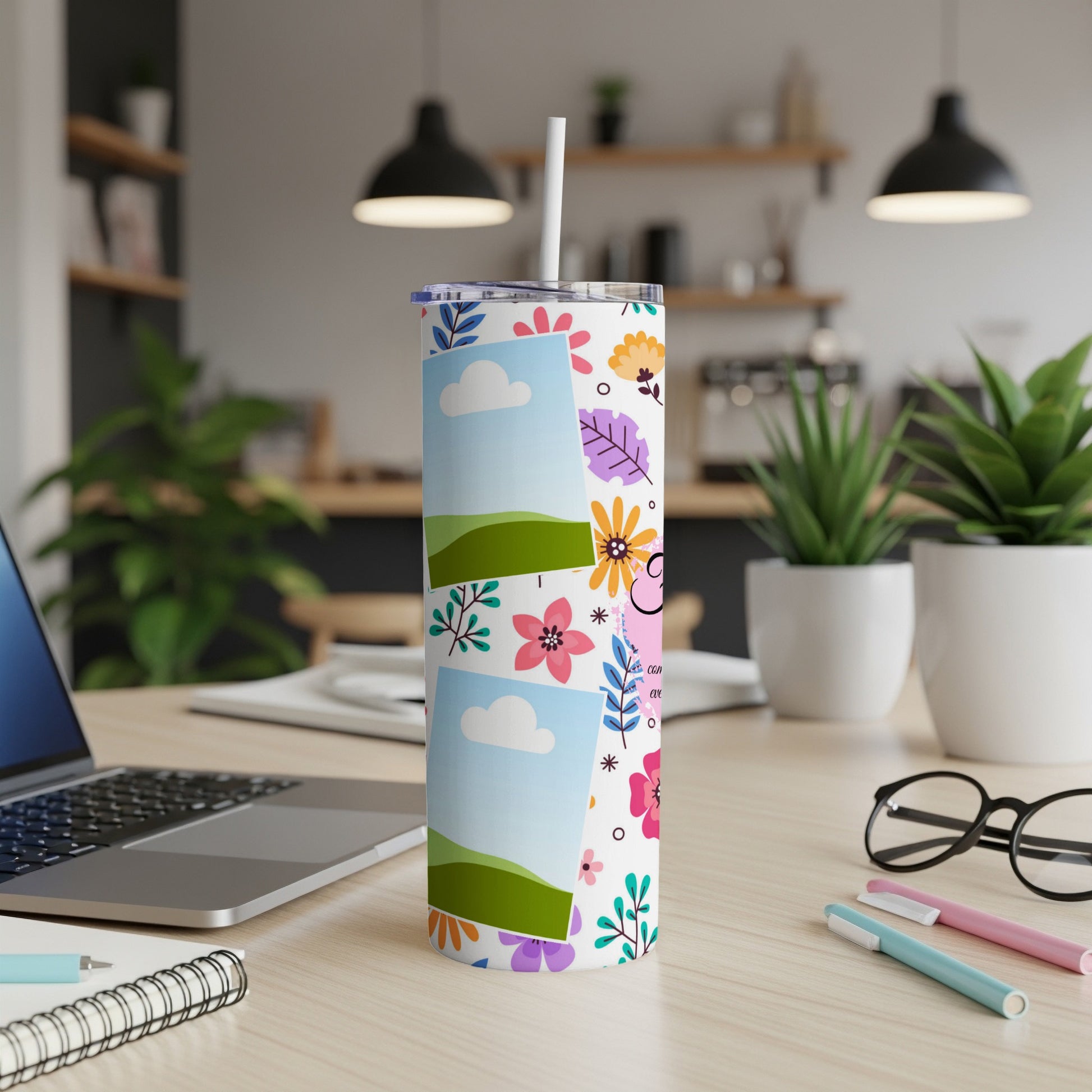 White tumbler with floral pattern, sky and grass photo inserts, and a straw.