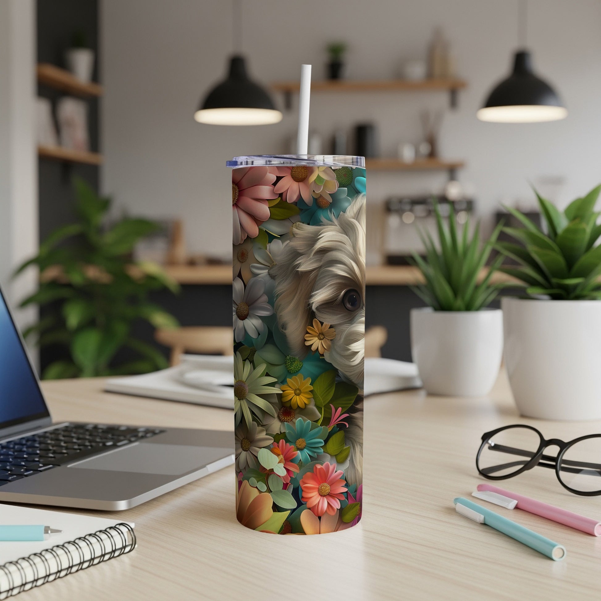 Yorkie face with flowers on a tumbler with laptop and pens.