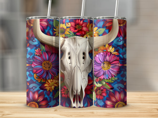 Skull with vibrant floral patterns and bull horns on a tumbler.