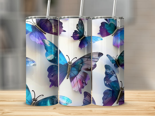 Three tumblers featuring colorful butterflies against a blurred background.