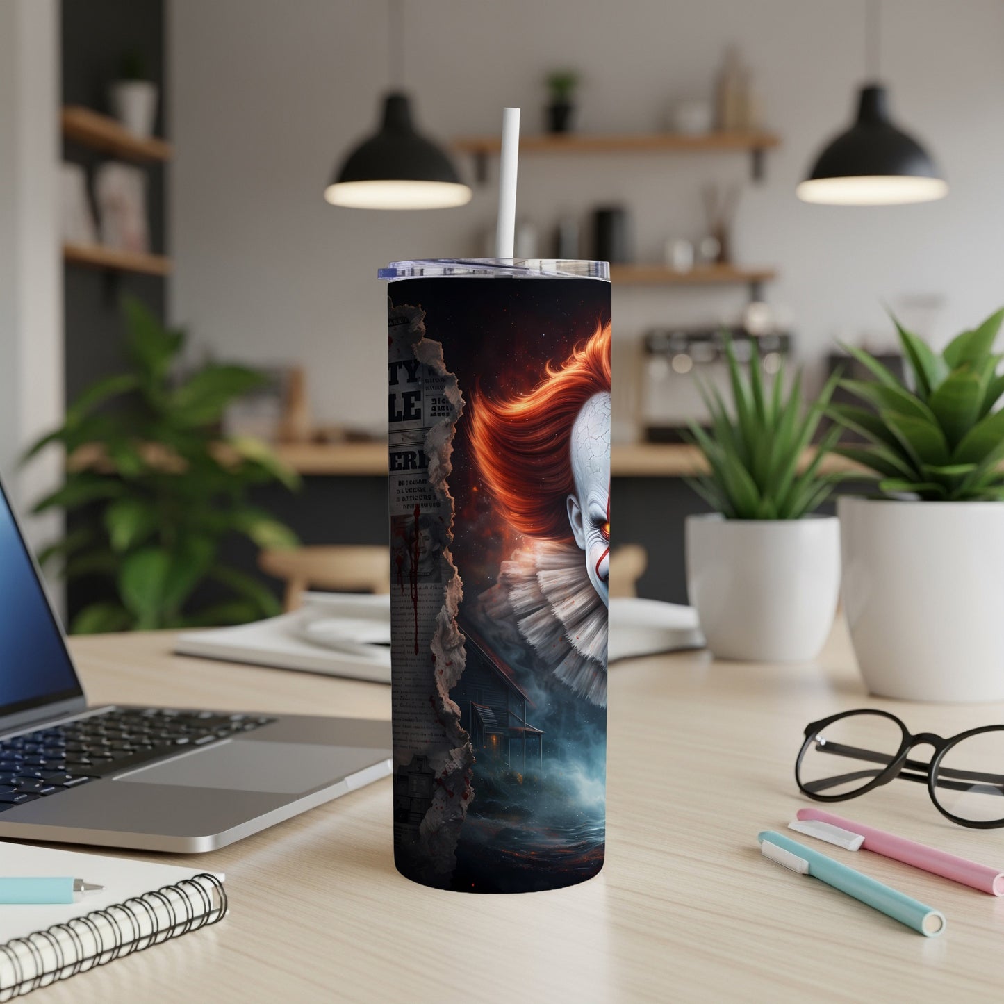 Tumbler featuring a torn newspaper graphic and a close-up of a scary clown face.