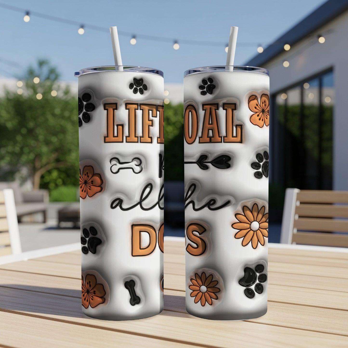 Tumbler with "Life goal: all the dogs" and dog paw prints.