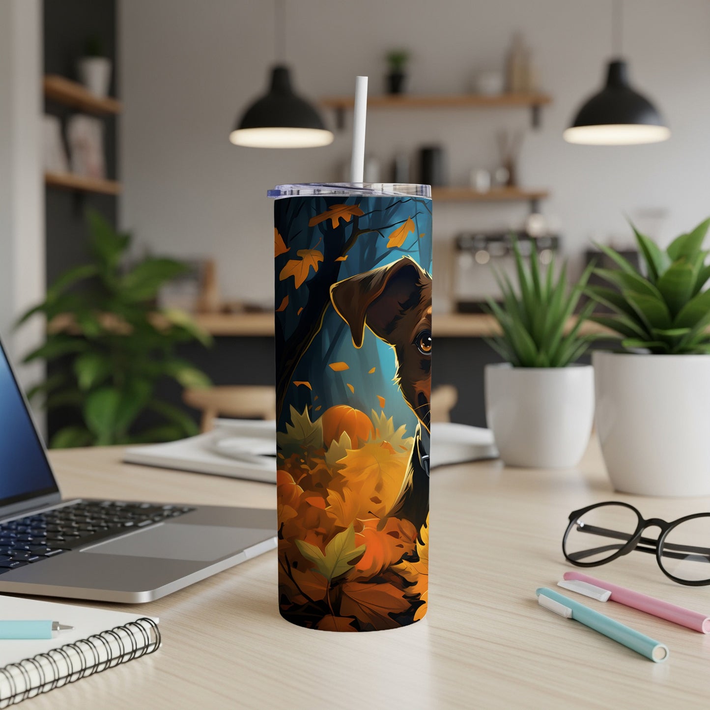Dog in autumn leaves art on a tall tumbler with a straw.