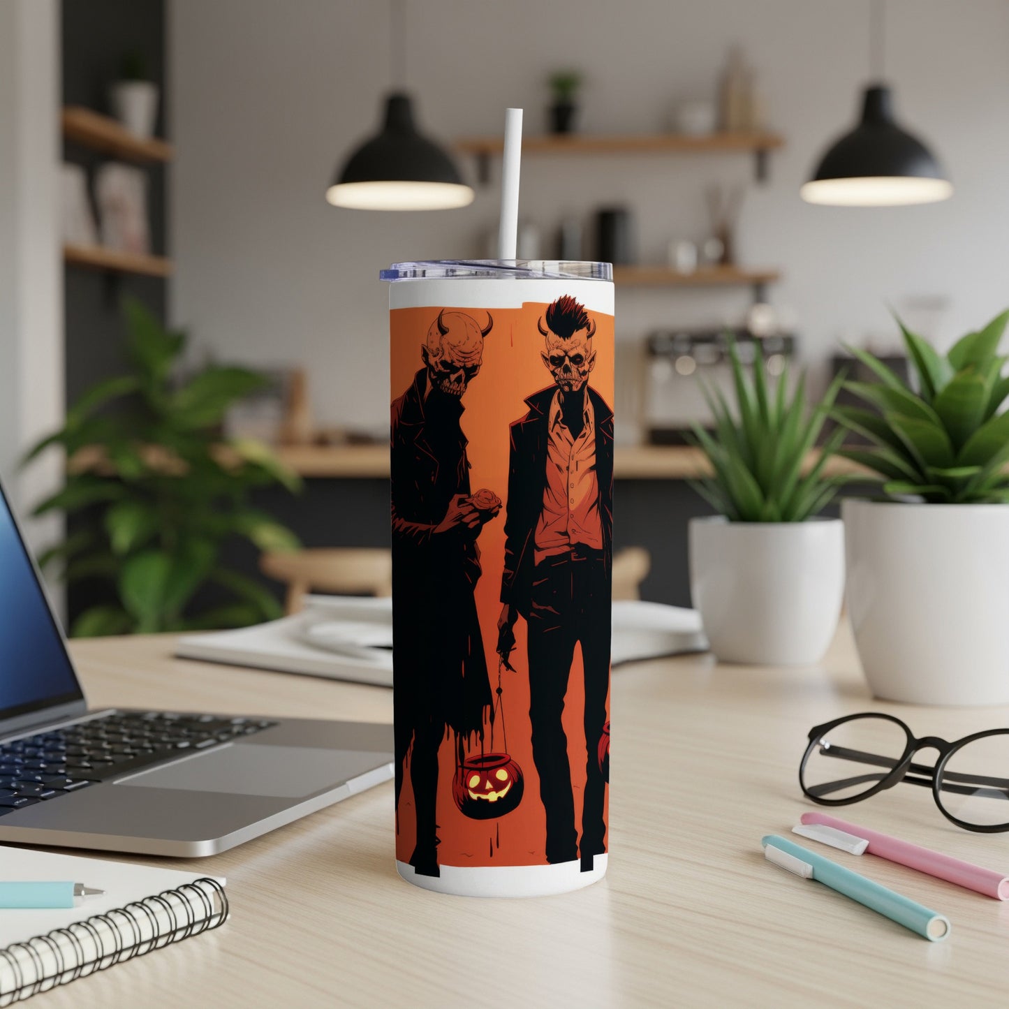 Tumbler with two skeletal figures holding jack-o'-lanterns against orange background.
