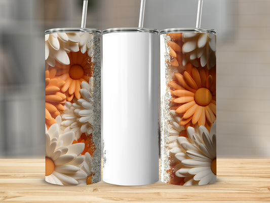 Three tumblers with floral designs and glitter accents on a wooden surface.