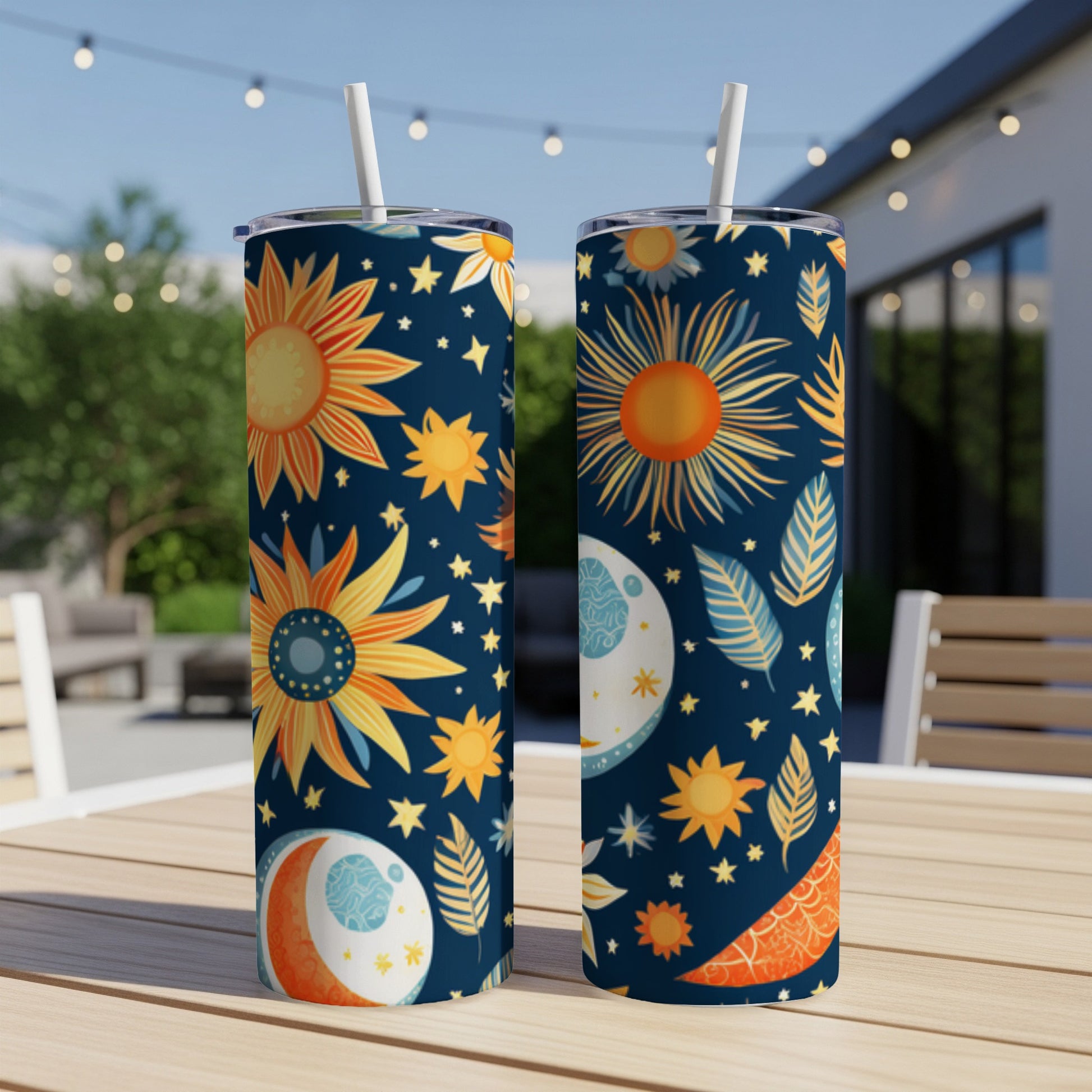 Two tumblers with celestial sun, moon, and star pattern on a navy background.