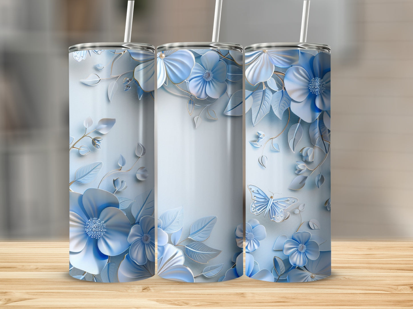 Three tumblers with blue floral designs and butterflies.