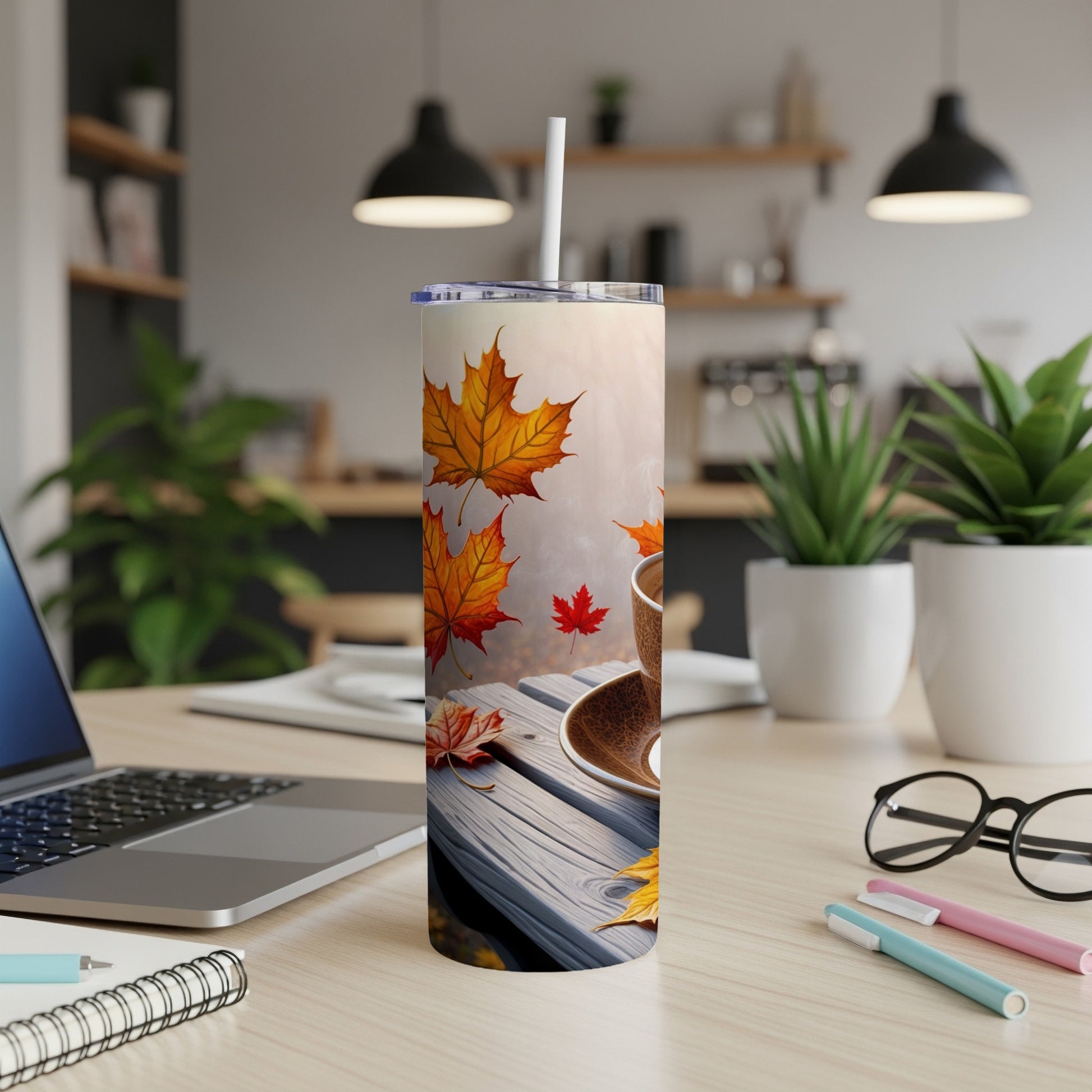 Tumbler with falling autumn leaves and a coffee cup.