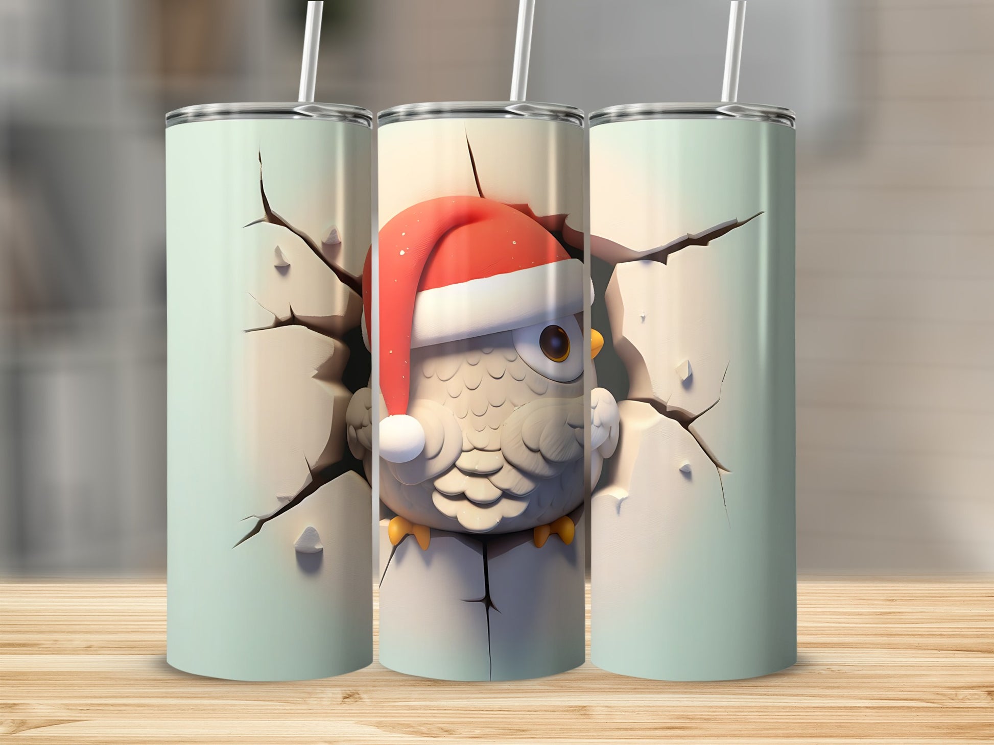 Three mint green tumblers, one with a cartoon owl wearing a Santa hat cracking through.