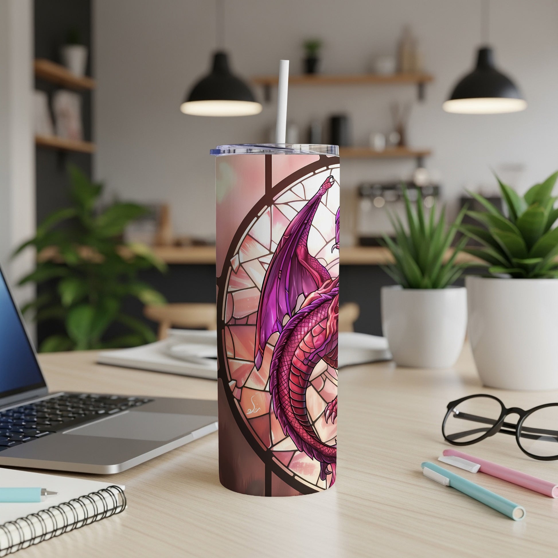 Dragon stained glass design on a pink and white tumbler with a straw.