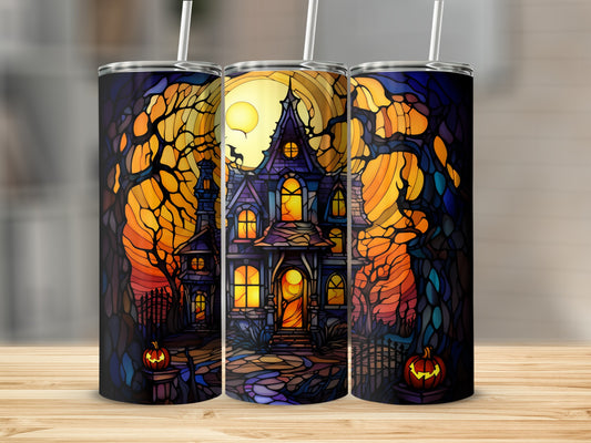 Stained glass tumbler with haunted house, pumpkins, and spooky trees under a full moon.