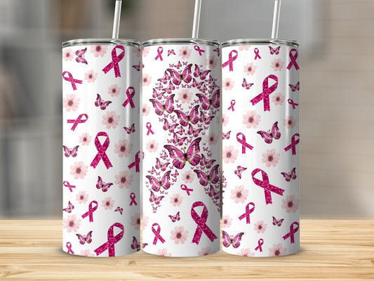 Three tumblers with pink ribbons and flowers design on a wooden surface.