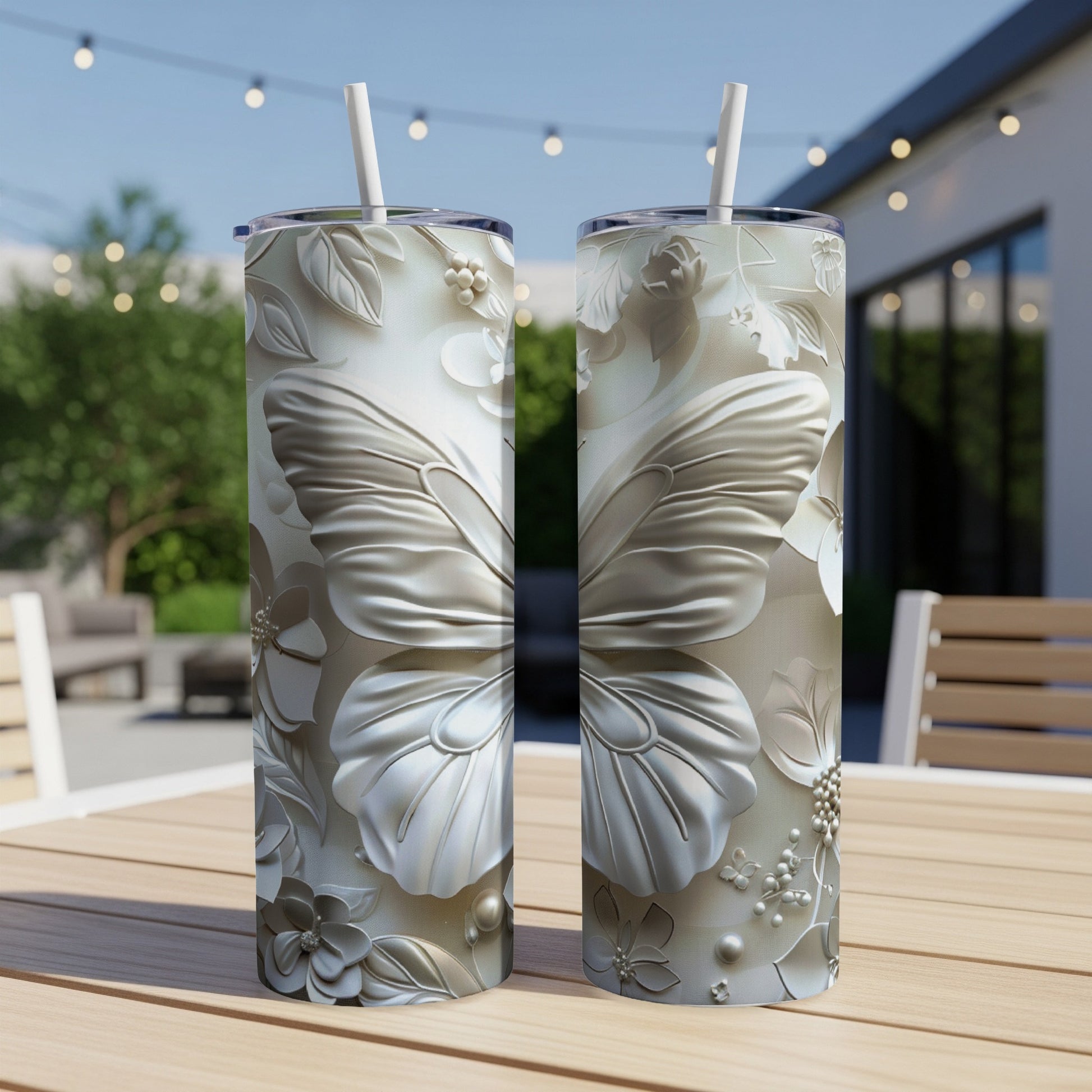 Two silver tumblers with intricate butterfly and floral embossed designs.