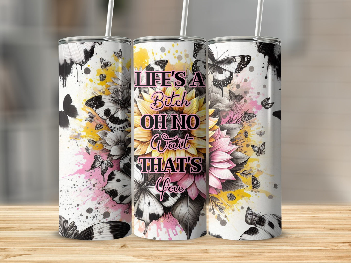 Tumbler with "Life's a Bitch Oh No Wait That's You" and floral butterfly design.