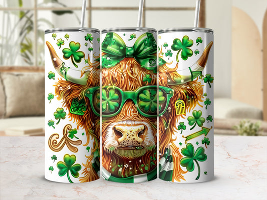 Highland cow wearing shamrock sunglasses and green bow, on St. Patrick's Day tumbler.