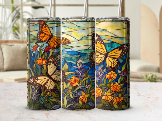 Three stained-glass tumblers with orange butterflies and floral patterns.