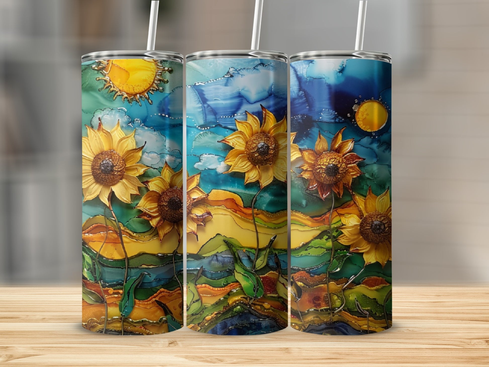 Three tumblers with a vibrant, painterly sunflower and landscape design.