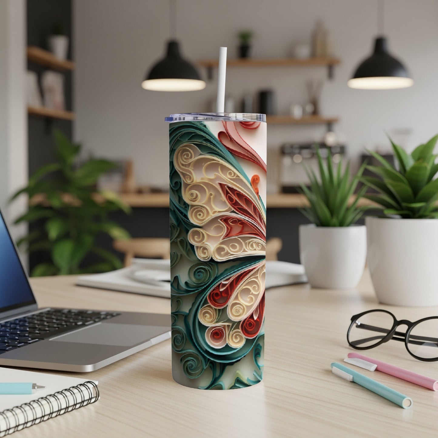 Tall tumbler with a colorful butterfly design and a white straw.