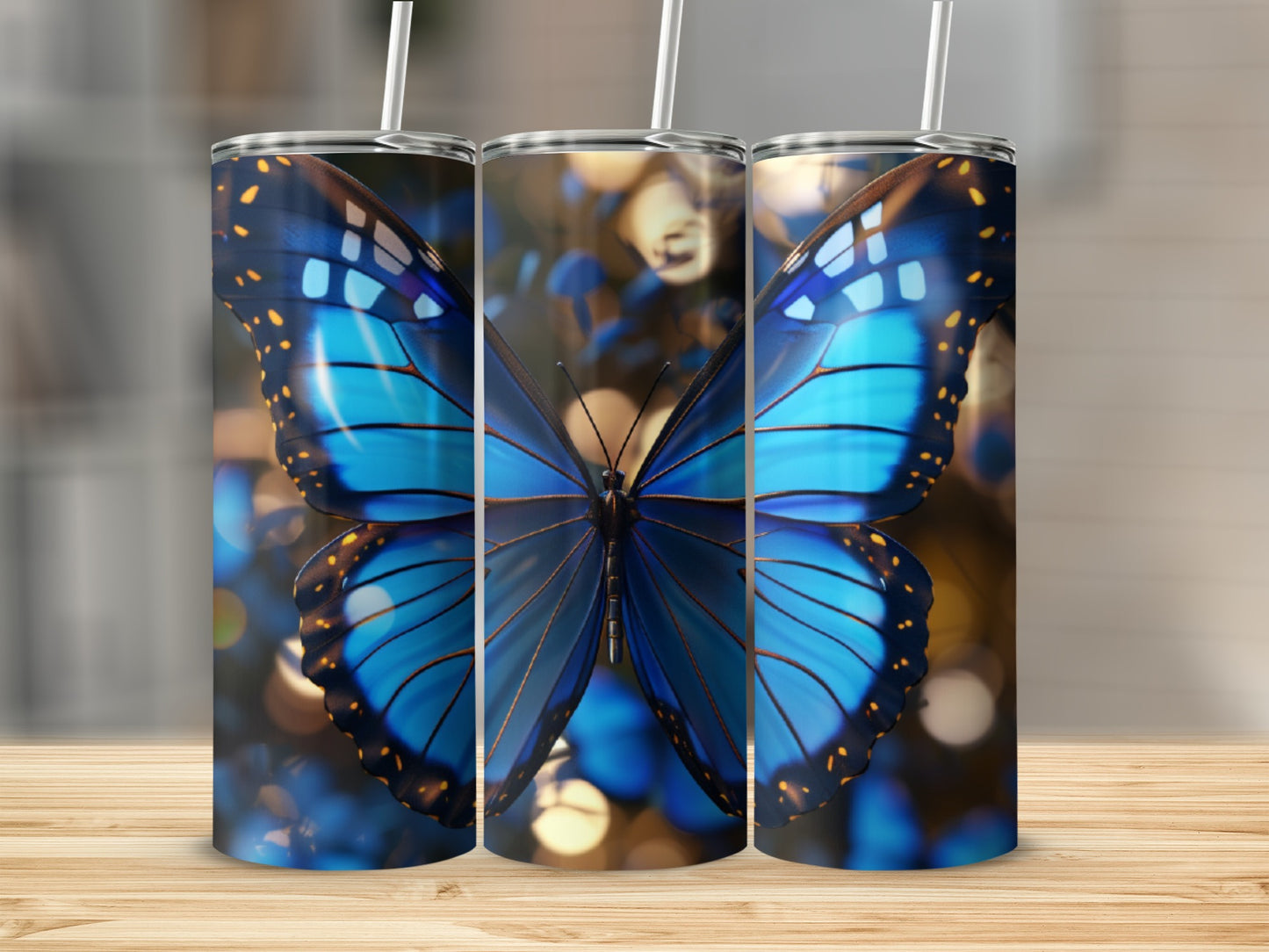 Three tumblers featuring a vibrant blue butterfly on a bokeh background.