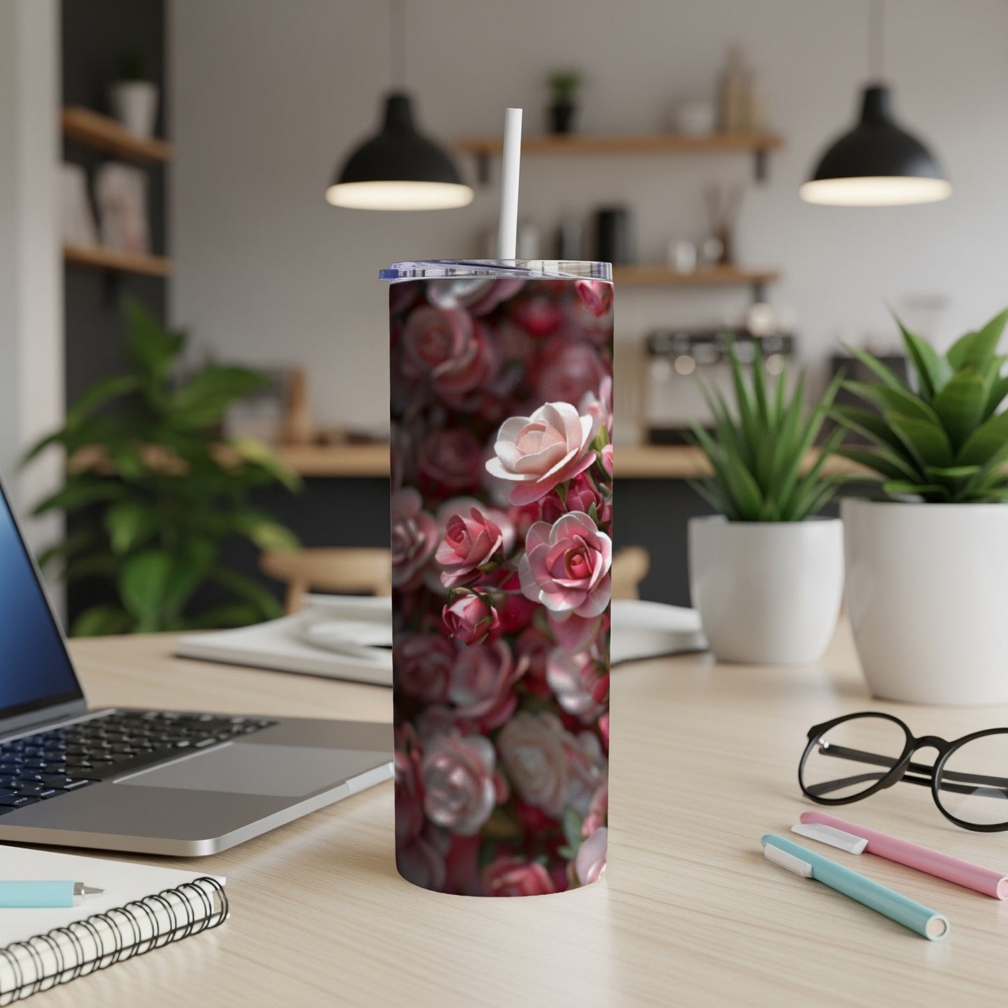 Pink and white roses pattern on a stainless steel tumbler.