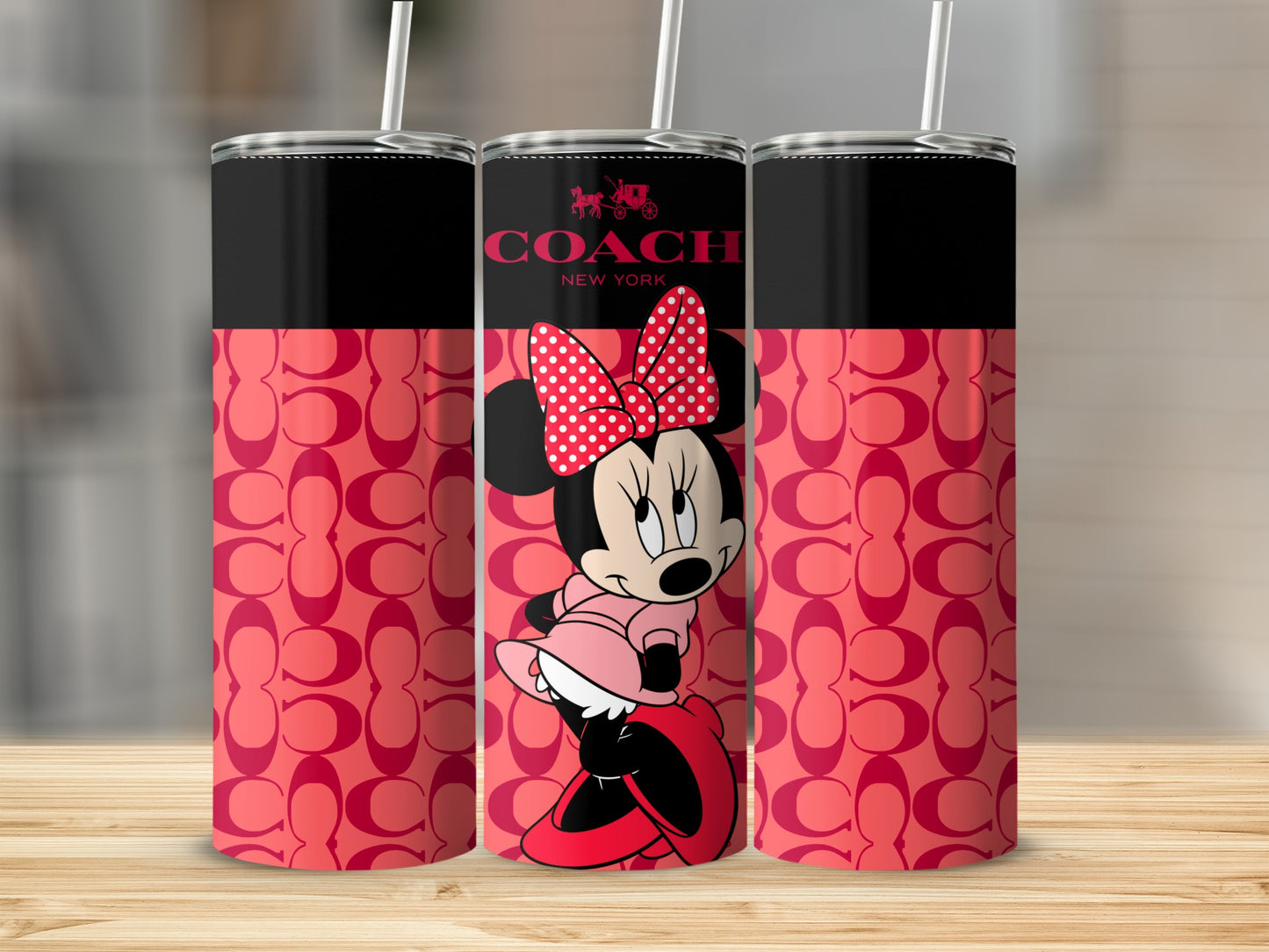 Coach New York Minnie Mouse tumbler with pink pattern and straw.