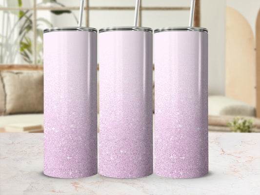 Three pink glitter gradient tumblers with straws, displayed on a counter.