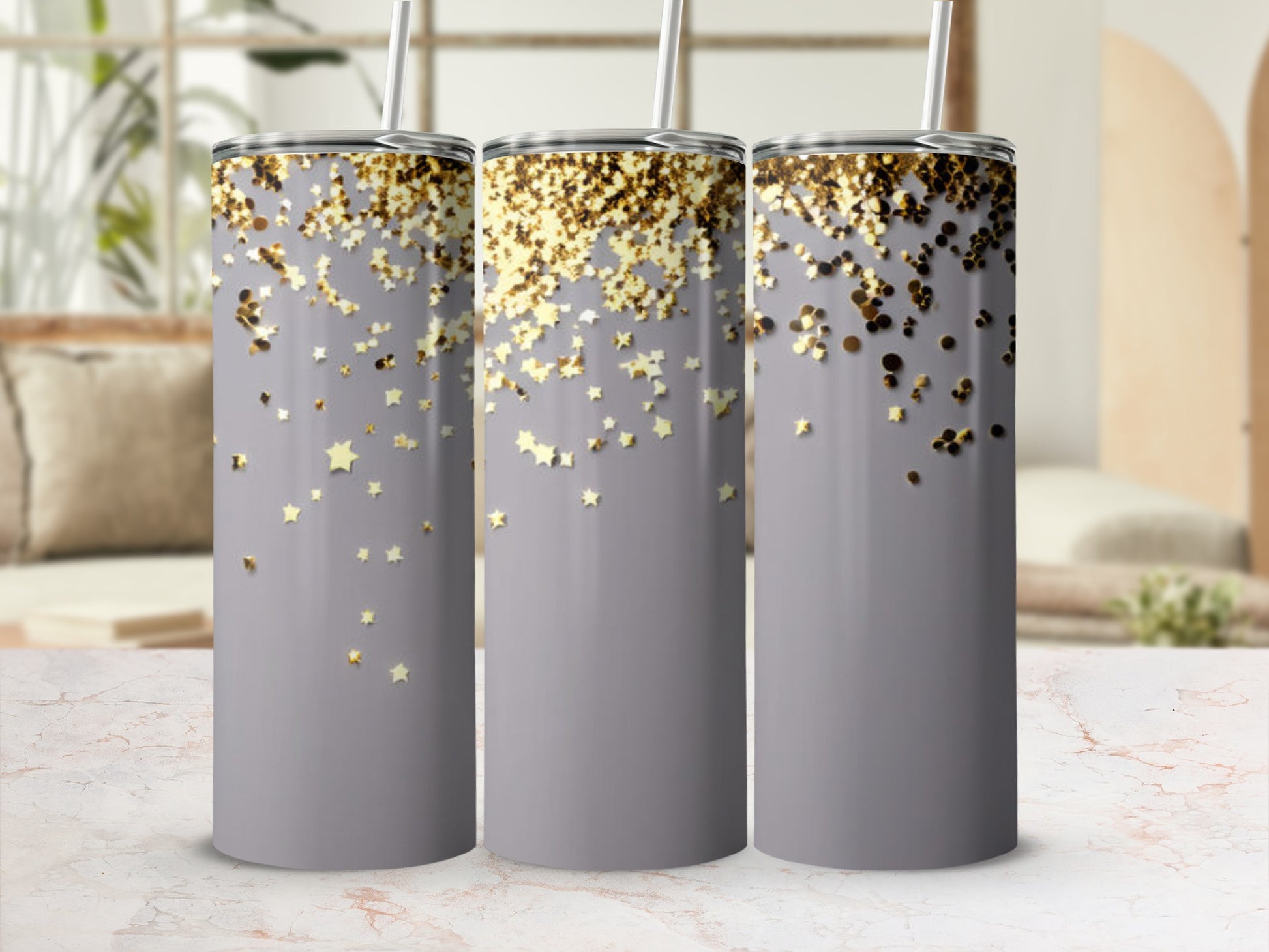 Three tumblers with gold glitter stars on a gray background.