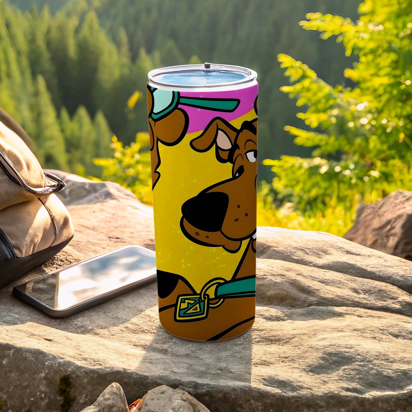 Scooby-Doo tumbler with yellow background, outdoors on rocks.