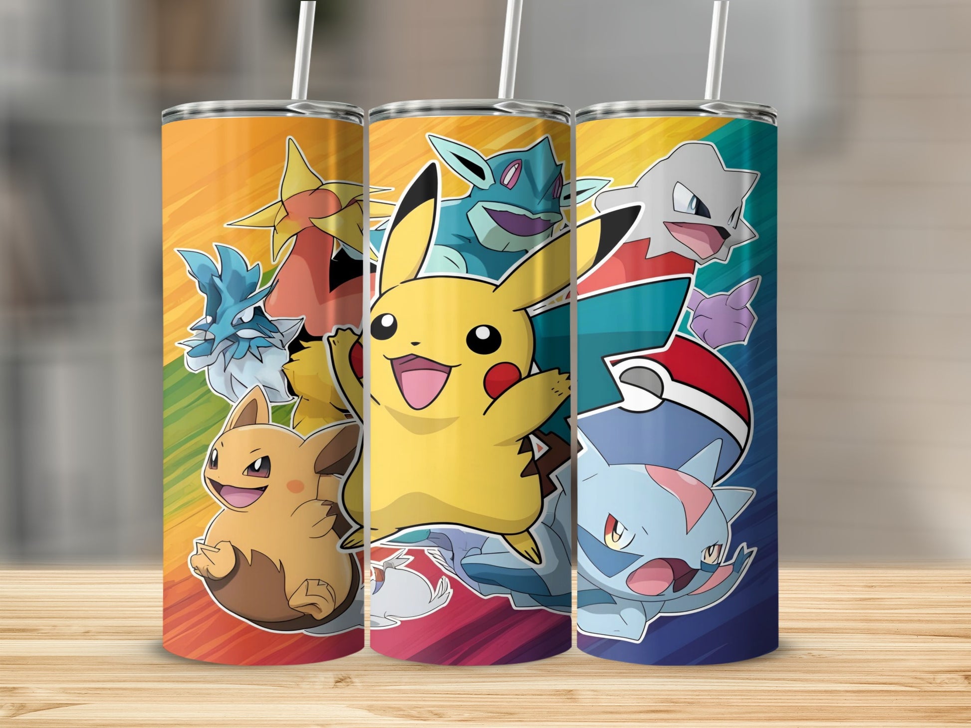 Three Pokémon tumblers featuring Pikachu, Gible, and other characters on a rainbow background.