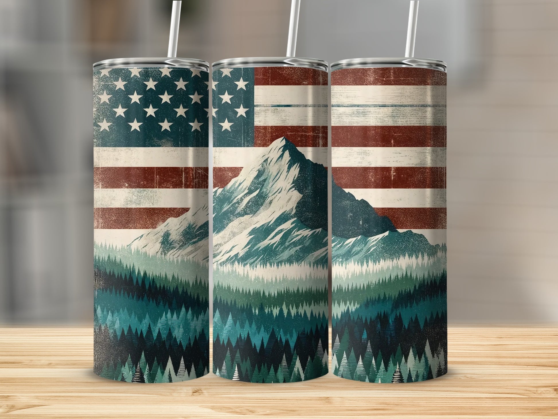 American flag over a mountain and pine forest scene on three tumblers.