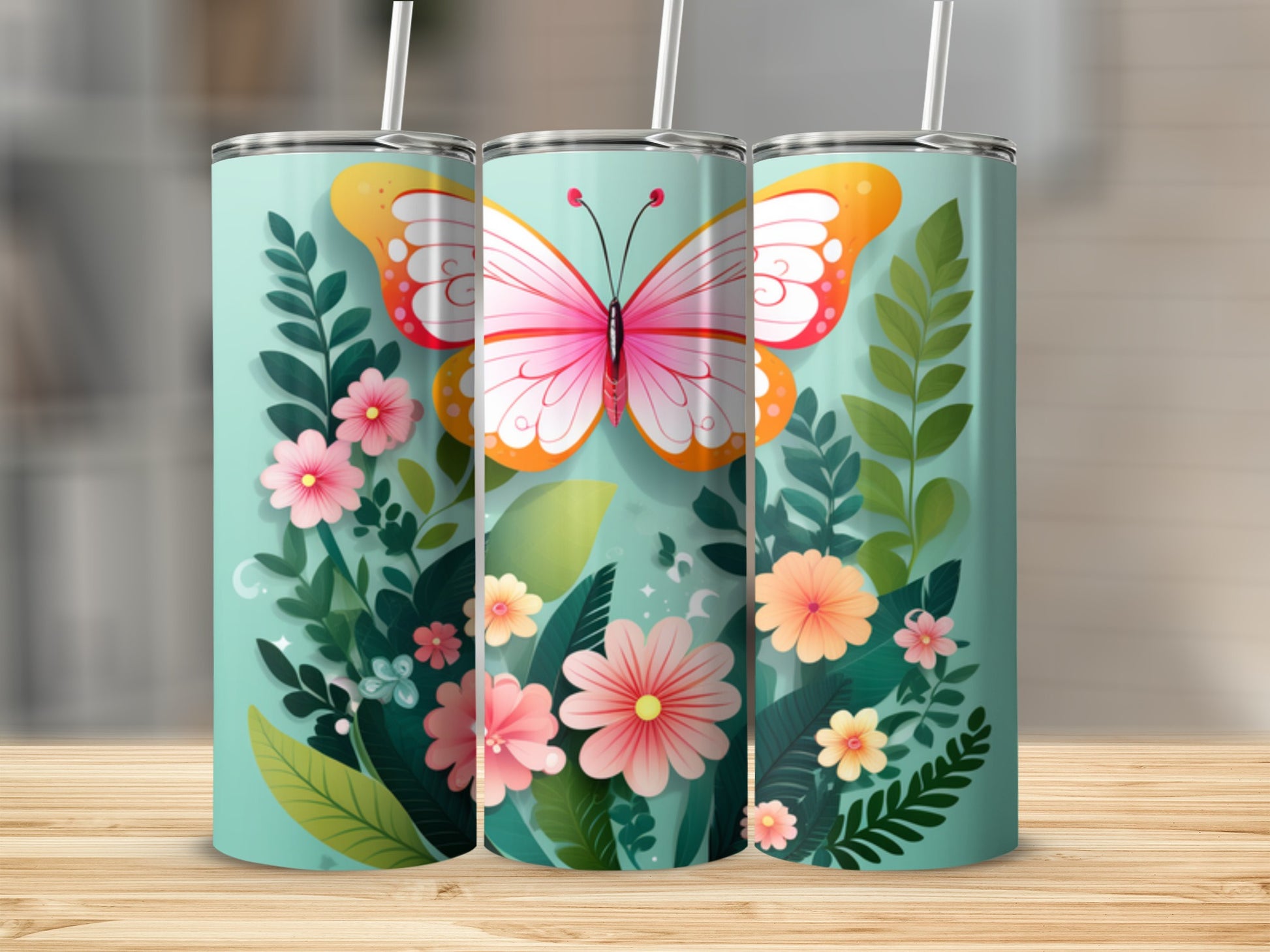 Three tumblers with butterflies and pink and orange flowers on a teal background.