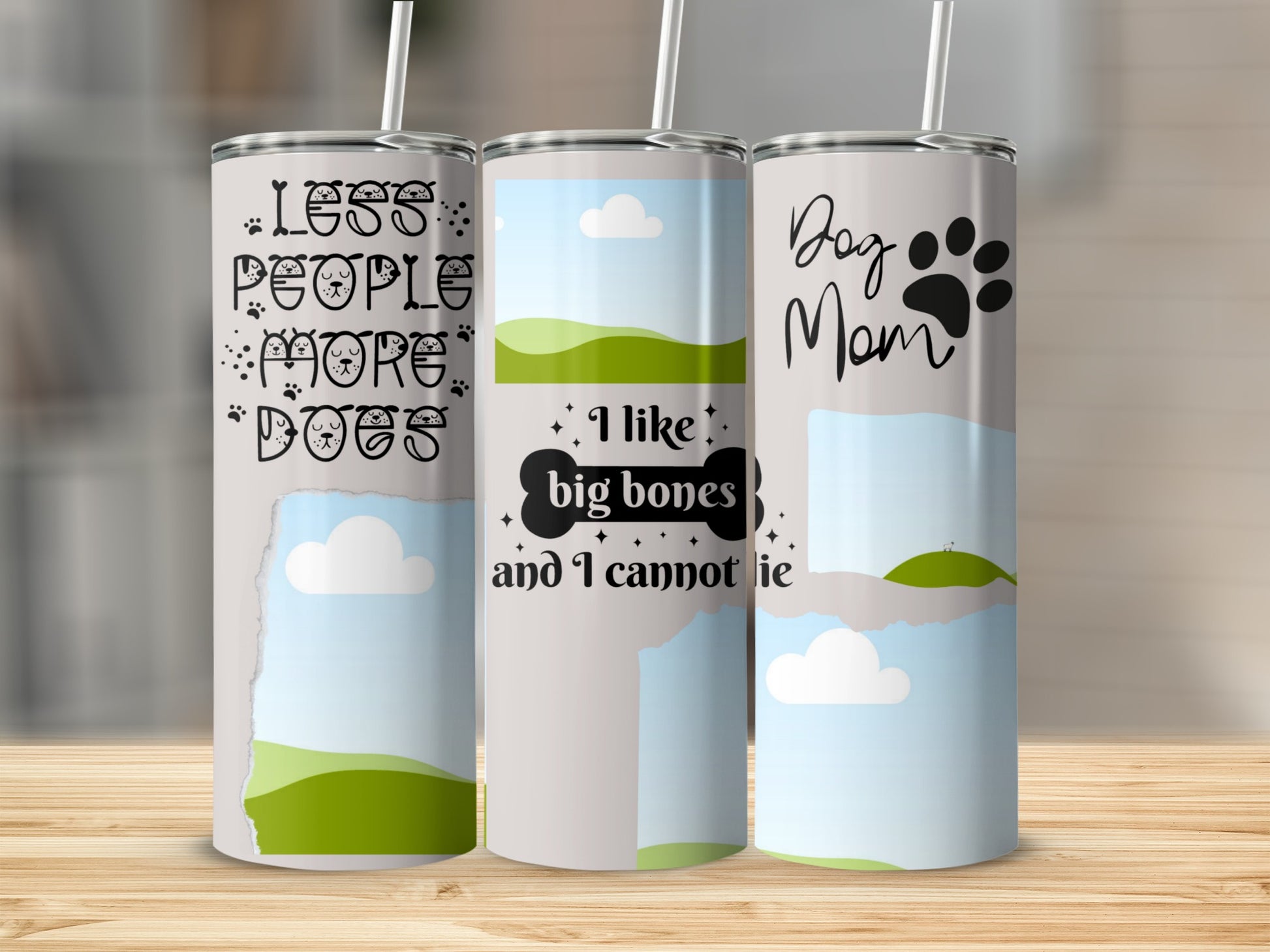 Three tumblers with dog-themed designs: "Less People More Dogs," "I like big bones and I cannot lie," and "Dog Mom."