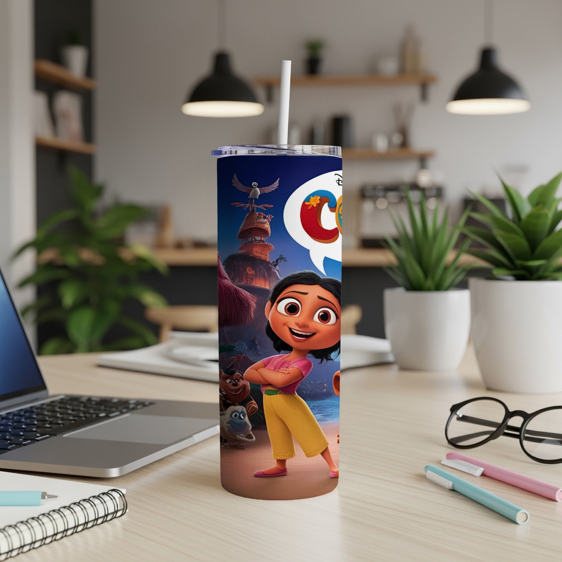 Tumbler with cartoon characters, text "YAY!" and a straw in a home office setting.
