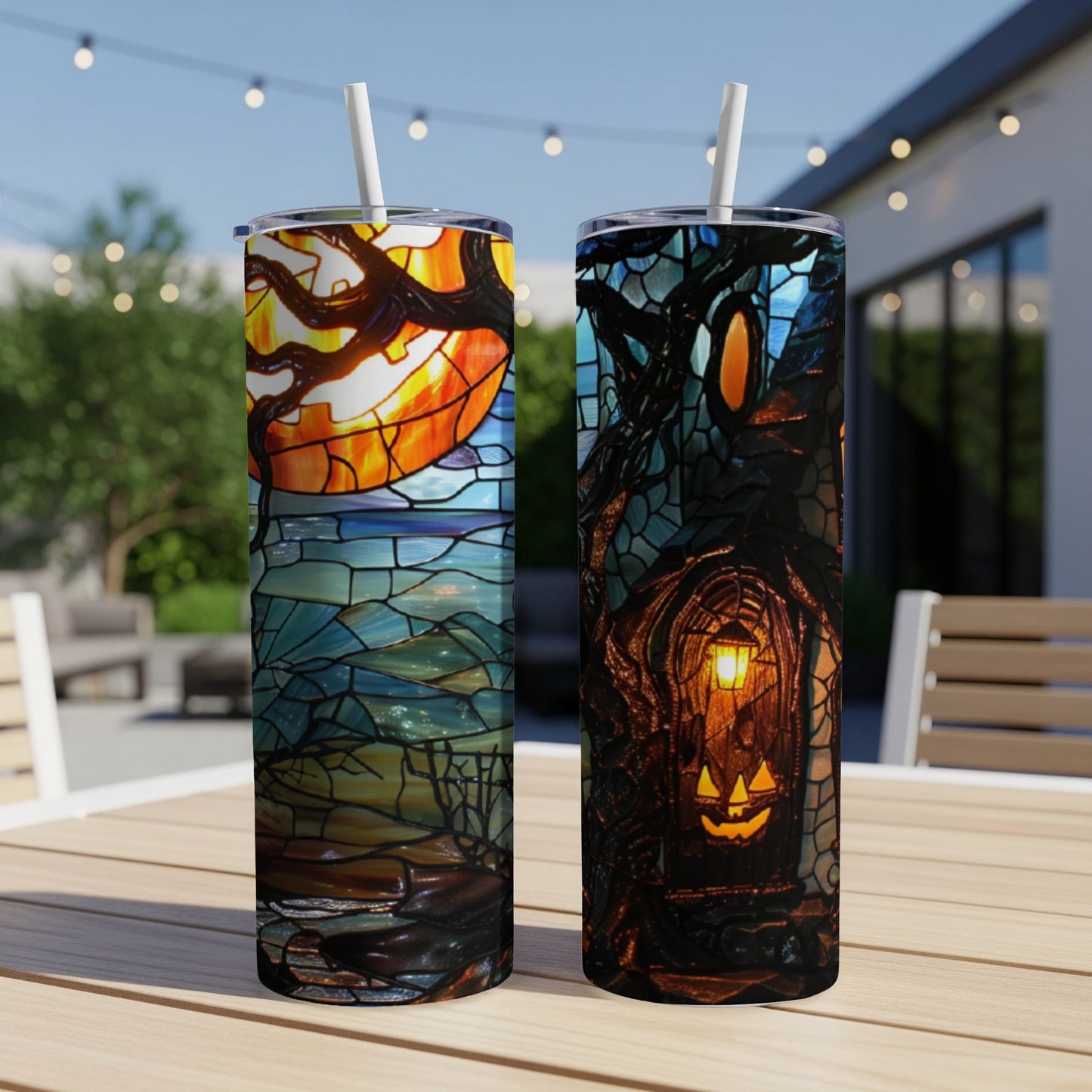 Two tumblers with Halloween stained glass designs, one with a pumpkin moon, the other a haunted house.