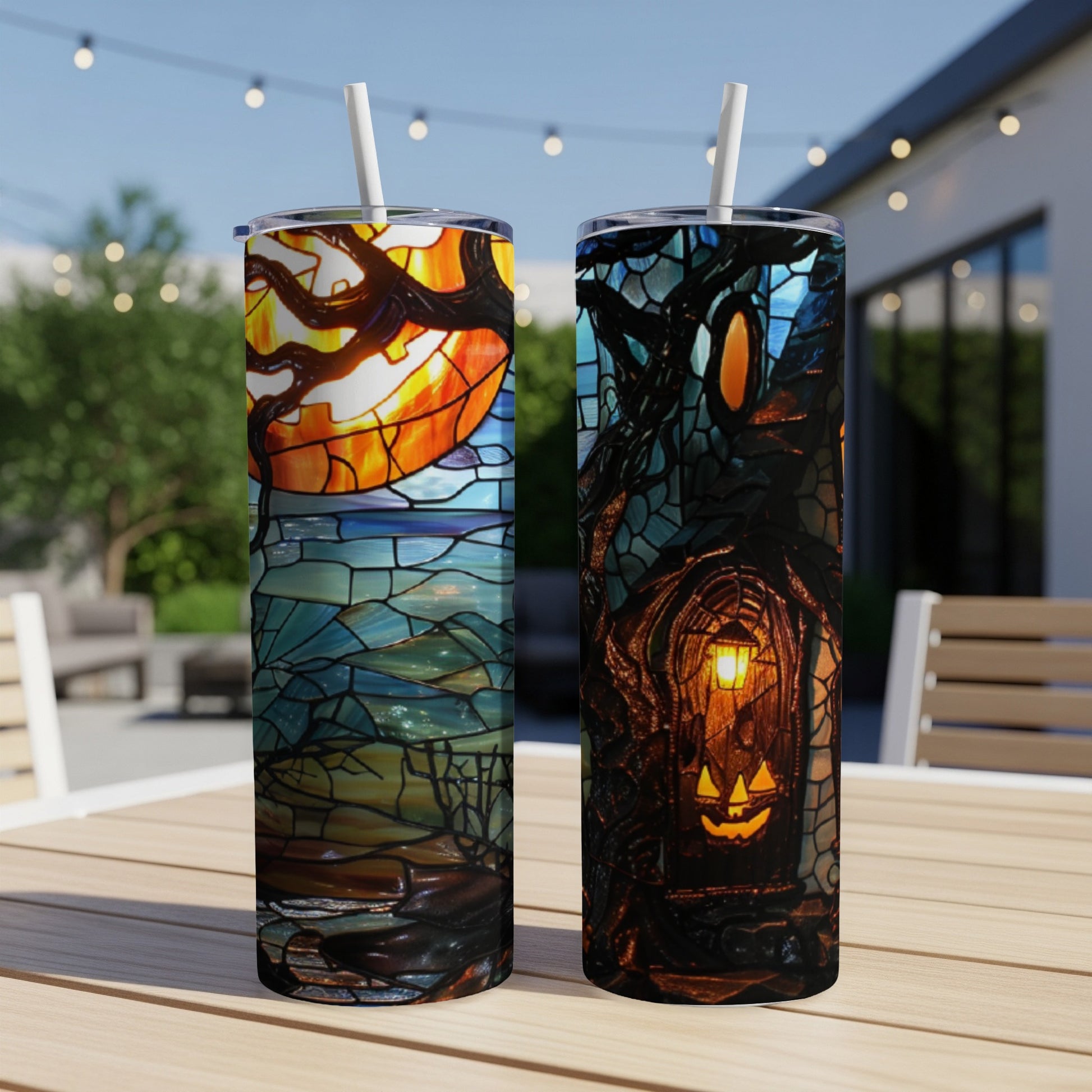 Two tumblers with Halloween stained glass designs, one with a pumpkin moon, the other a haunted house.