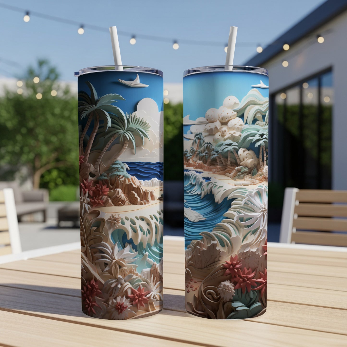 Two tropical beach scene tumblers with straws on a wooden table.