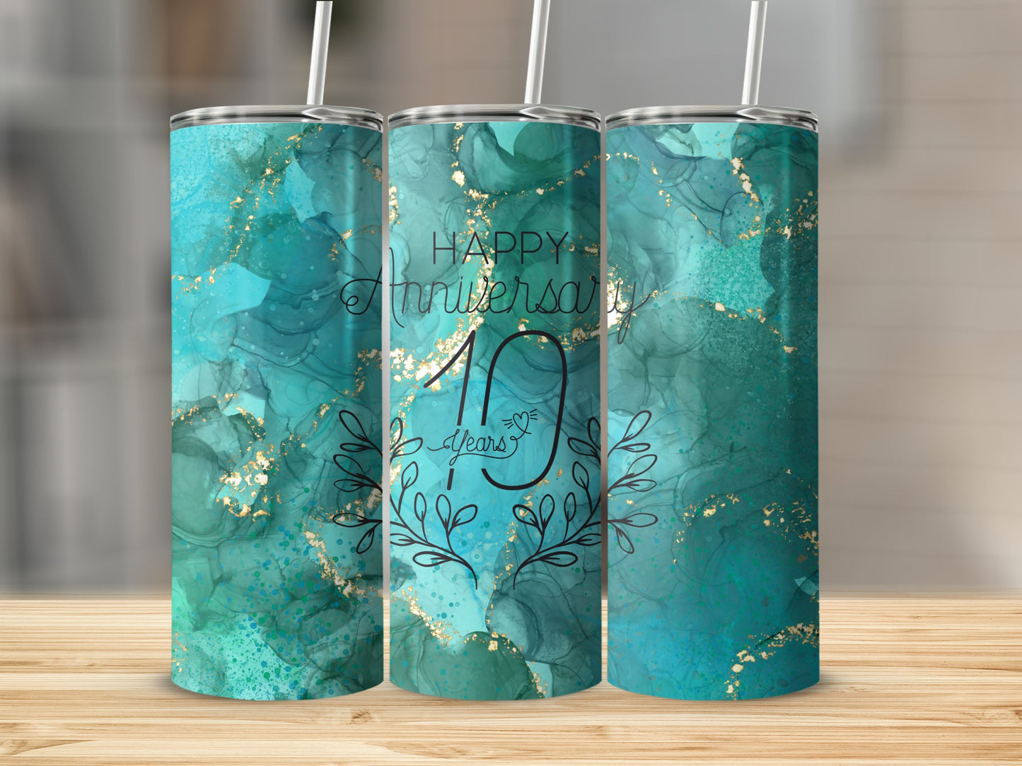 "Happy Anniversary 10 Years" text on a teal watercolor tumbler with gold splatters.