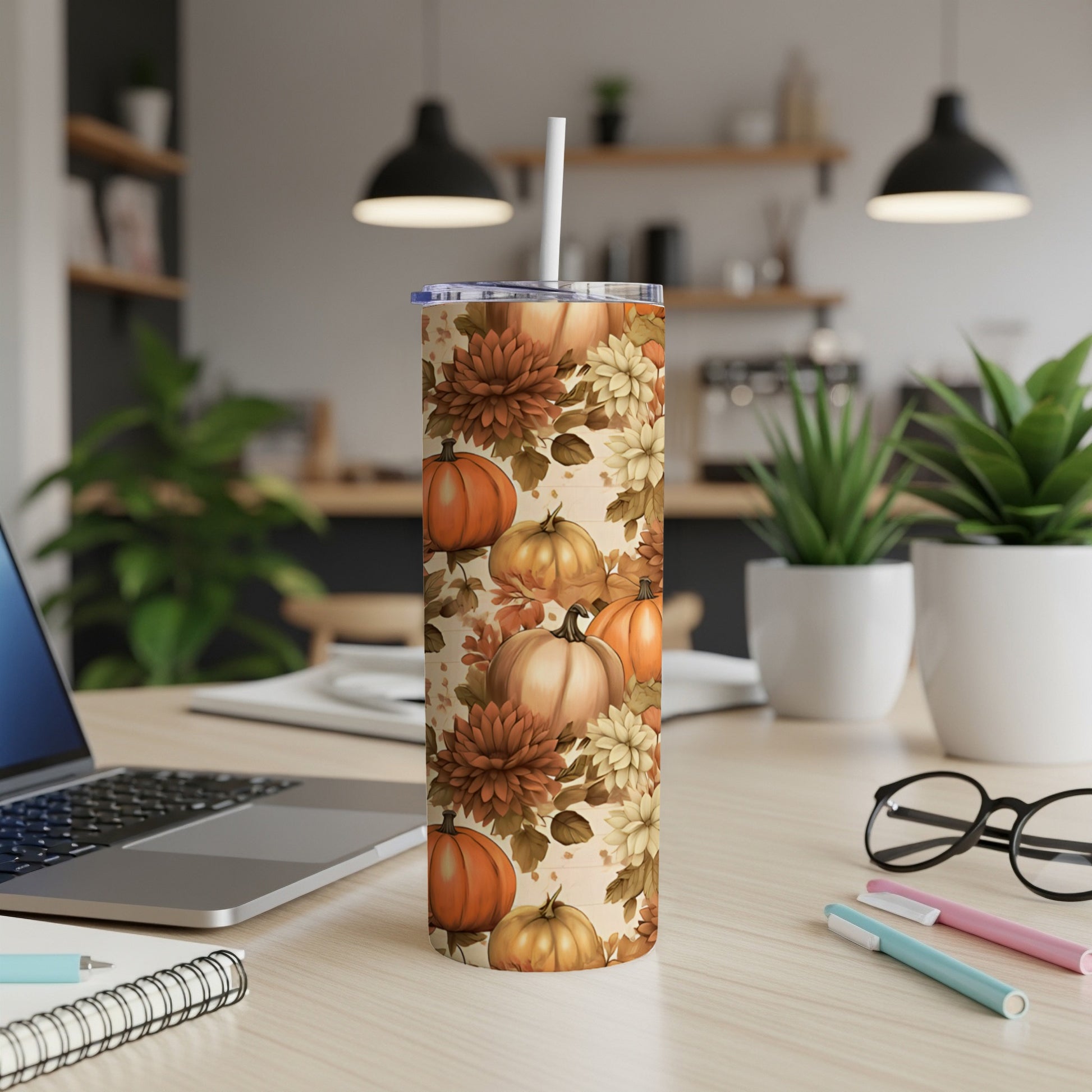 Fall-themed tumbler with pumpkins and flowers, straw inserted.