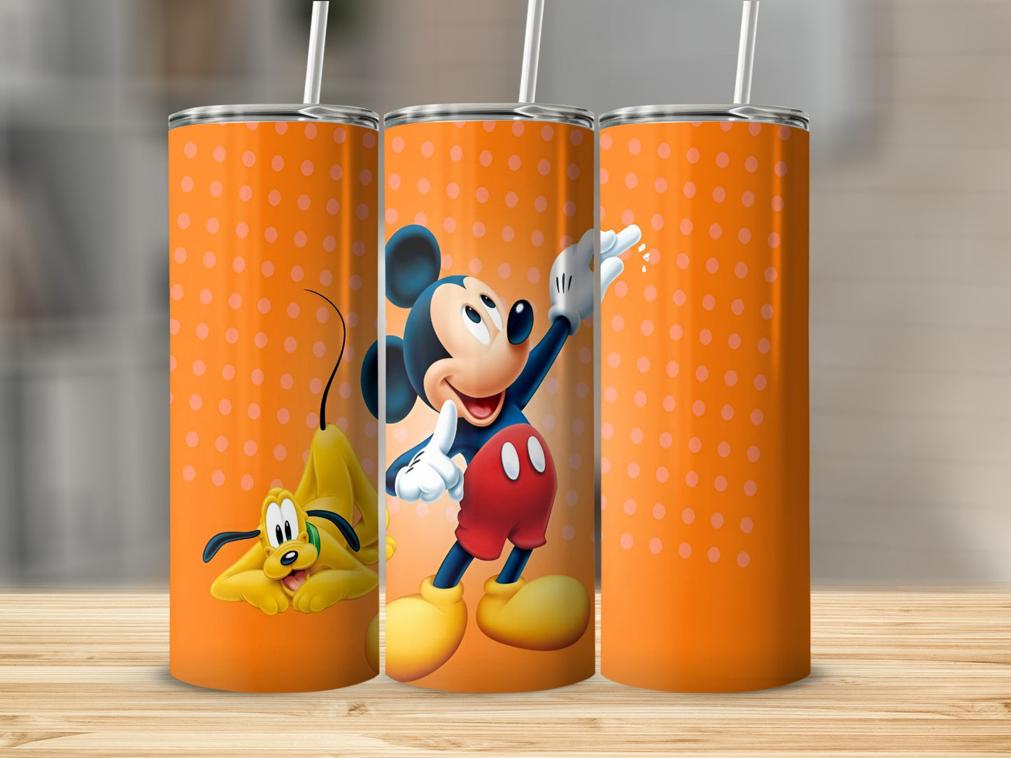 Three orange tumblers with polka dots featuring Mickey Mouse and Pluto.
