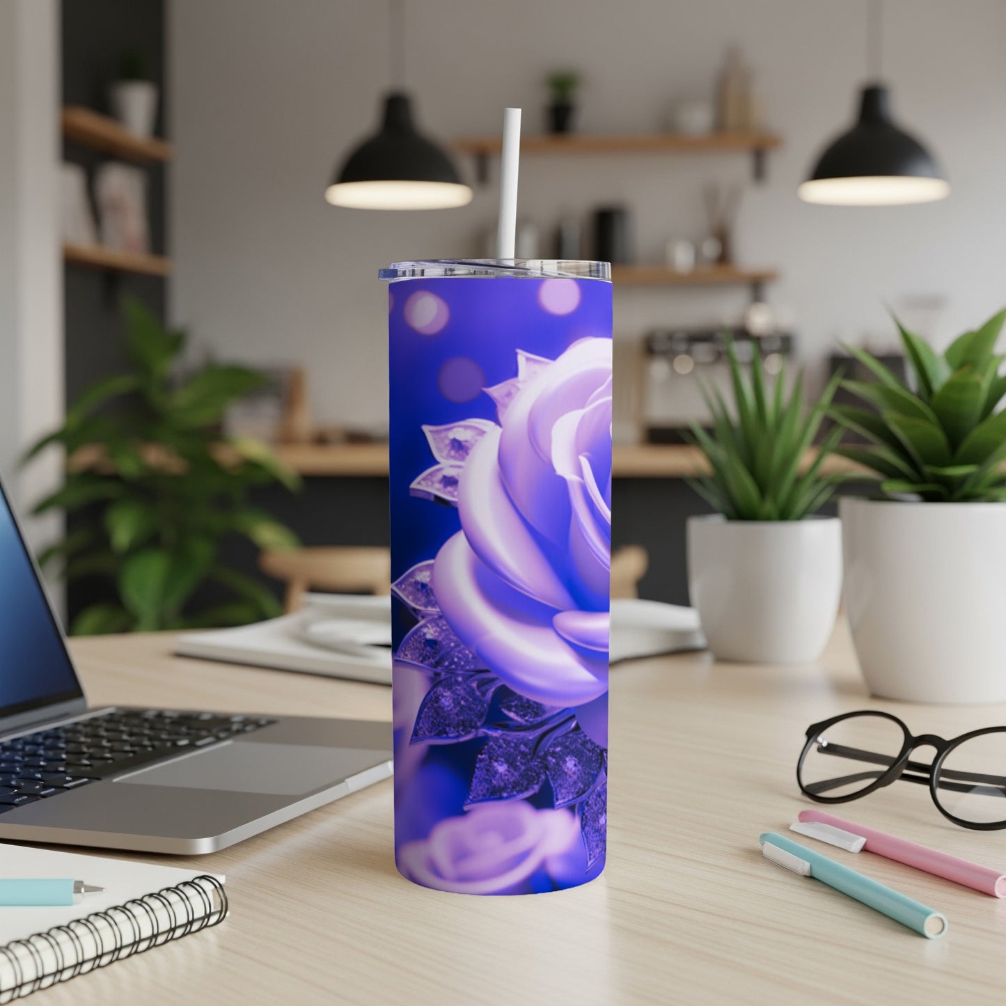 Purple rose tumbler with glitter accents on a desk with a laptop.