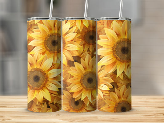 Three tall tumblers with a vibrant sunflower pattern on a wooden surface.
