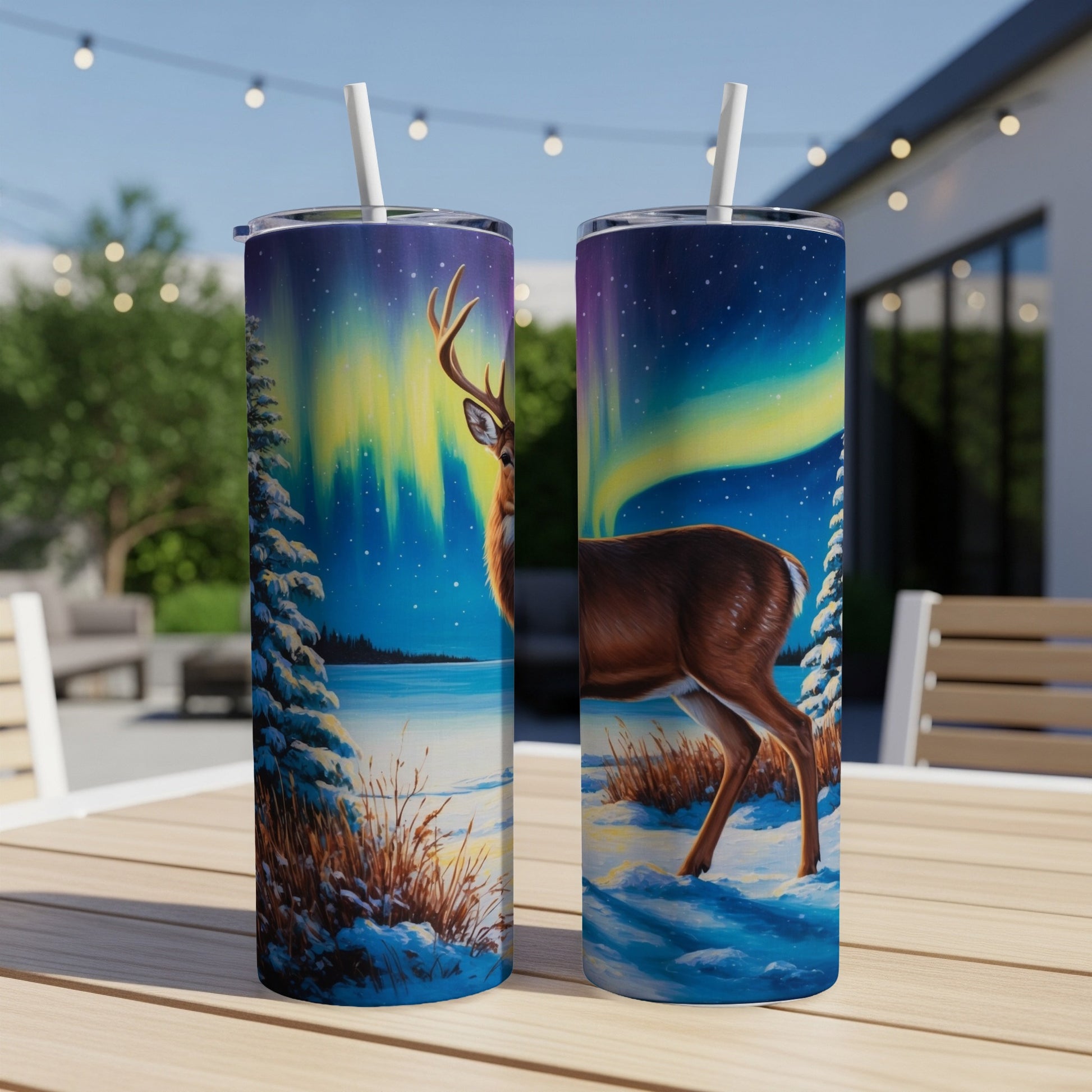 Two tumblers feature a deer in a snowy landscape with the aurora borealis.