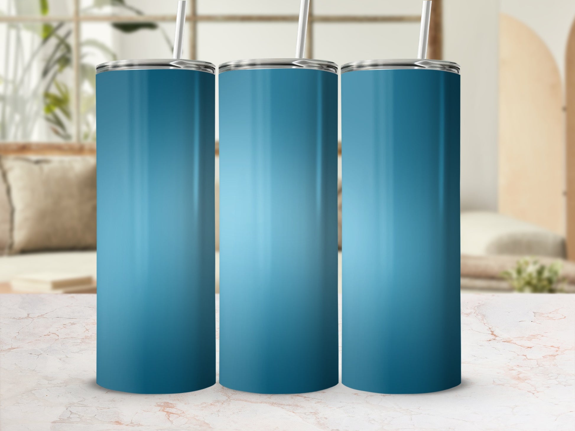 Three tall blue tumblers with straws stand on a marbled surface.