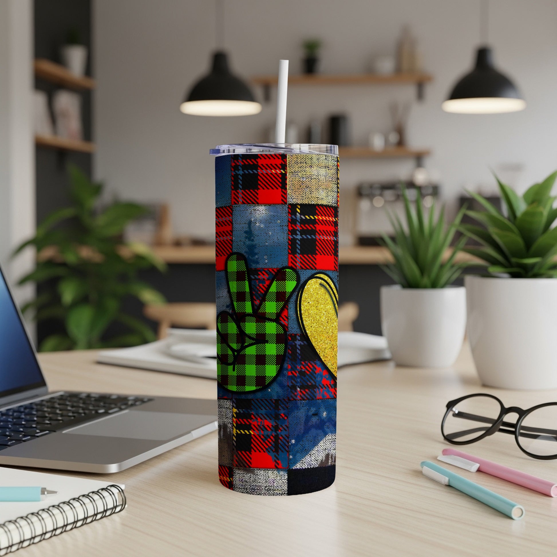 Peace sign and heart pattern on a tumbler with a white straw.