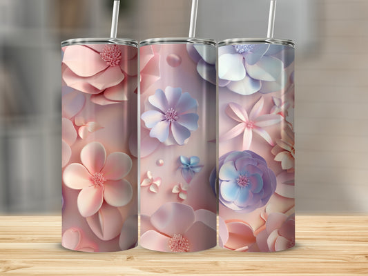 Three tumblers with pastel floral designs on a wooden surface.