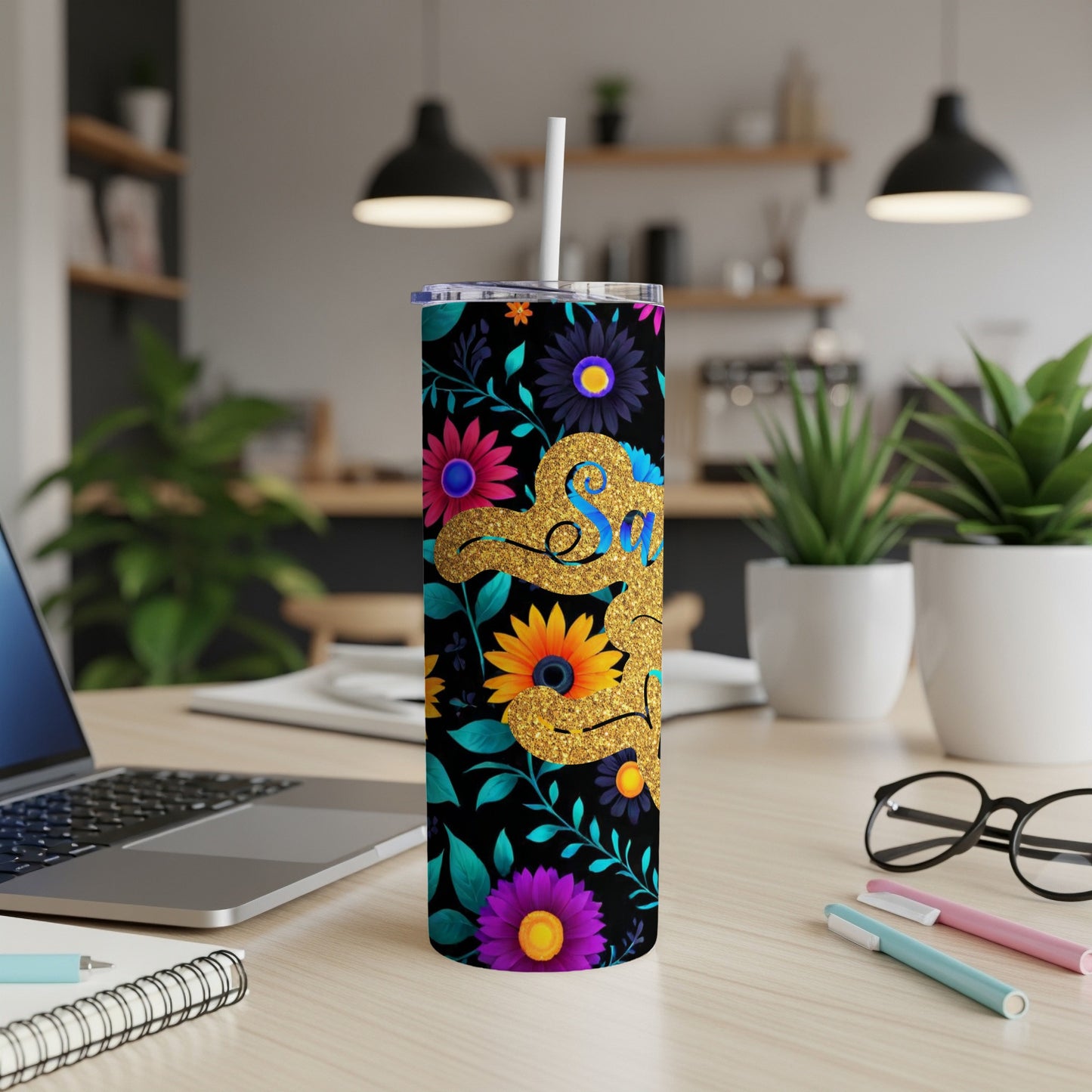 Gold "Salsa" text on black tumbler with floral and plant designs.